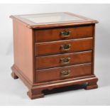 A Modern Four Drawer Chest on Bracket Feet with Glazed Bijouterie Top, 57cm wide and 55cm High