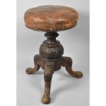 A Late Victorian Carved Leather Seated Circular Topped Adjustable Piano Stool on Tripod Support