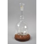 A Hand Blown Glass Ship in a Bottle, on Wooden Stand, The Mayflower, Overall Height 32cm