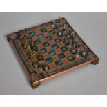 A Small Metal Chessboard with Brass and Pewter Playing Pieces, The Kings 4cm high, Board 21cm Square