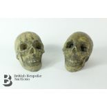 Two Stone Human Skulls