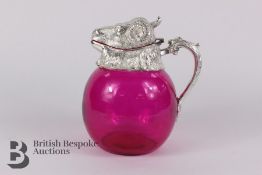 An Unusual Rams Head Cranberry Claret Jug