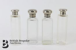 Four Silver-Topped Vanity Bottles