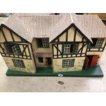 A LARGE VINTAGE WOODEN DOUBLE FRONTED DOLLS HOUSE BY TRIANG WITH METAL WINDOWS CIRCA 1930'S