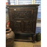 A HEAVY CARVED OAK CONTINENTAL CUPBOARD 116 X50 X 165CM