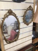 A PAIR OF VINTAGE ORNATE AND GILDED FRAMED MIRRORS OF OVAL FORM LARGEST IS 49 X 28CM