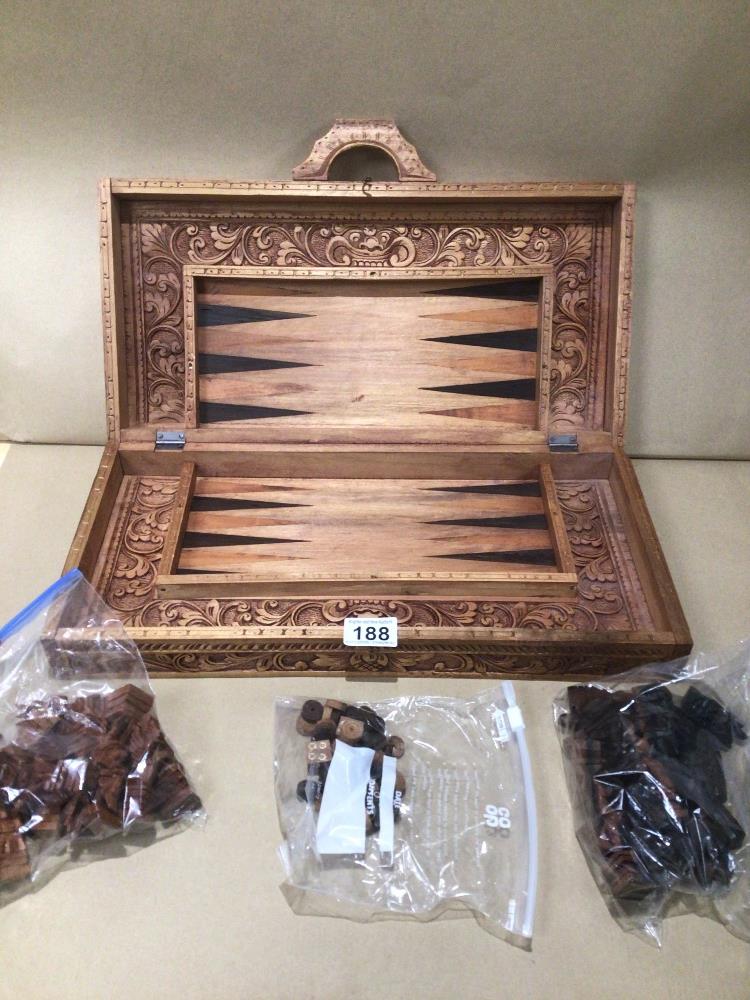 A VINTAGE DECORATIVE CARVED WOOD SUITCASE CHESS AND BACKGAMMON GAME SET