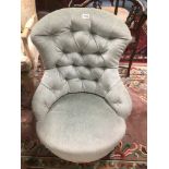 A VINTAGE UPHOLSTERED BUTTON BACK CHAIR