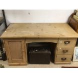 A VICTORIAN PERIOD PINE KNEE-HOLE DESK WITH THREE DRAWERS AND CUPBOARD (ONE PIECE) 153w x 77h x