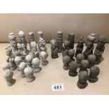 A CARVED STONE PART CHESS SET (ONE PIECE MISSING)
