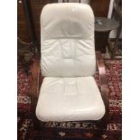 A CREAM LEATHER CHAIR WITH WOODEN ARMS