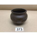 A SMALL CHINESE BRONZE POT DECORATED AROUND THE SIDE WITH A DRAGON MARKED TO BASE 8CM DIAMETER 493