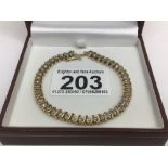 AN UNMARKED TENNIS LADIES 14 CARAT BRACELET LINED WITH FORTY-FOUR DIAMONDS TOTAL LENGTH 18CM,