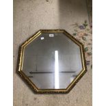 A GILDED OCTAGONAL SHAPED BEVELLED MIRROR 55CM DIAMETER