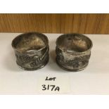 A PAIR OF CHINESE SILVER NAPKIN RINGS BY YOKSANG DECORATED WITH DRAGONS 73 GRAMS