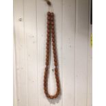 A LARGE BUTTERSCOTCH SET OF AMBER BEADS AS A NECKLACE COMPRISES OF 44 BEADS 3 X 2.5 CM WITH 2
