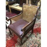 A VICTORIAN BERGERE CHAIR FLUTED FRONT LEGS ON ORIGINAL CASTORS WITH LEATHER SEAT