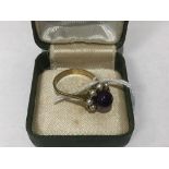 AN AMETHYST AND PEARL CLUSTER RING AMETHYST BEAD STONE SURROUNDED WITH EIGHT CULTURED PEARLS IN A