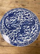 A BLUE AND WHITE CIRCULAR CHINESE PORCELAIN PLAQUE WITH DETAILED CHASING DRAGONS 37CM DIAMETER