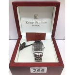 A BOXED WITH PAPERS GENTS STEEL KRUG BAUMEN TUXEDO WATCH