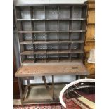 A FRENCH INDUSTRIAL METAL POSTMASTER BENCH WITH PIGEON HOLES AND ADJUSTABLE SEAT
