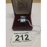AN 18CT WHITE GOLD RING WITH A 12 X 10MM TOPAZ STONE WITH THREE DIAMONDS ON EACH SHOULDER SIZE S