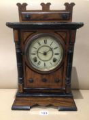 A 19TH CENTURY GERMAN WALNUT AND EBONISED MANTLE CLOCK WITH A CIRCULAR DIAL 43CM HIGH