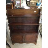 A VINTAGE MAHOGANY WATERFALL BOOKCASE WITH BOTTOM CUPBOARD