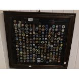 A FRAMED AND GLAZED COLLECTION OF ENAMEL BOWLING BADGES FROM AROUND THE WORLD 64 X 60CM