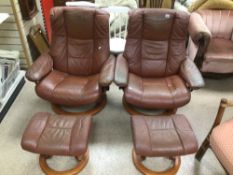 A PAIR OF EKORNES STRESSLESS PINK ARMCHAIRS WITH STOOLS