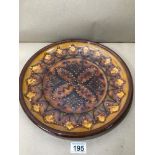 A VINTAGE ART POTTERY PLATE OF FLORAL DESIGN MARK TO BASE ILLEGIBLE 34CM (£15 P&P UK)