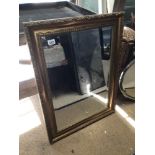 A MODERN GILDED BEVELLED EDGED MIRROR IN AN ORNATE FRAME 84 X 64CM