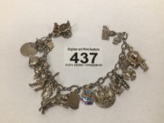 A STERLING SILVER CHARM BRACELET 16 CHARMS SOME LOSS TO RHODIUM PLATING, OTHERWISE GOOD