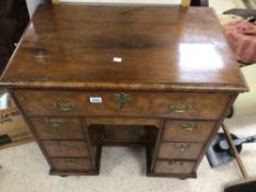 A GEORGE I WALNUT VENEERED KNEEHOLE DESK WITH FITTED INTERIOR (POSSIBLY ALTERED)
