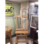 A LARGE ARTIST WOODEN EASEL WITH STORAGE