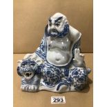 A VINTAGE ORIENTAL BLUE AND WHITE PORCELAIN BUDDHA FIGURE WITH A TIGER 23CM