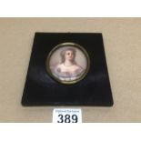 AN OVAL MINIATURE-HEAD AND SHOULDER PORTRAIT OF A YOUNG WOMAN 8 X 6CM