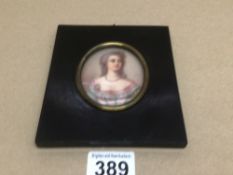 AN OVAL MINIATURE-HEAD AND SHOULDER PORTRAIT OF A YOUNG WOMAN 8 X 6CM