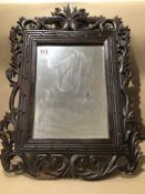 A SMALL WOODEN CARVED WALL MIRROR 58 X 42CM