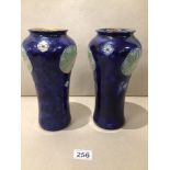 A PAIR OF ROYAL DOULTON GLAZED STONEWARE VASES WITH ART NOUVEAU ROUNDELS ON A BLUE GROUND 25CM