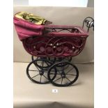 AN EARLY CHILDS TOY PRAM MADE FROM WICKER WITH CAST IRON WHEELS