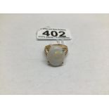 AN UNMARKED TESTED TO 15 CARAT RING WITH A FIRED OPAL STONE SIZE S