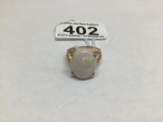 AN UNMARKED TESTED TO 15 CARAT RING WITH A FIRED OPAL STONE SIZE S