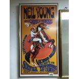 A FRAMED AND GLAZED NEIL YOUNG POSTER 63 X 33CM