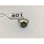 A 9CT GOLD DAISY RING, WITH CENTRAL DIAMOND SURROUND WITH 6 GREEN STONES SIZE P