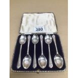 A CASED SET OF SIX HALLMARKED SILVER TEASPOONS WITH GOLF TERMINALS BY WALKER AND HALL