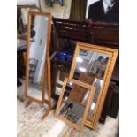 A PINE CHEVAL SWING MIRROR AND TWO WALL MIRRORS IN PINE