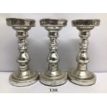 A SET OF THREE VINTAGE CHROME CANDLESTICKS APPROX 23CM TALL