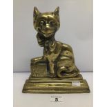 A CAST IRON AND BRASS WEIGHTED VICTORIAN DOORSTOP IN THE FORM OF A SEATED CAT 'YE CHESHIRE CAT',