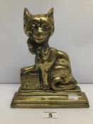 A CAST IRON AND BRASS WEIGHTED VICTORIAN DOORSTOP IN THE FORM OF A SEATED CAT 'YE CHESHIRE CAT',